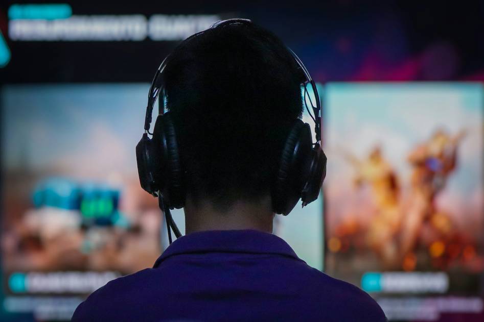 Group of diverse mobile gamers playing multiplayer games on smartphones with vibrant game UI overlays